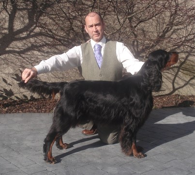 Man posing black and tan dog